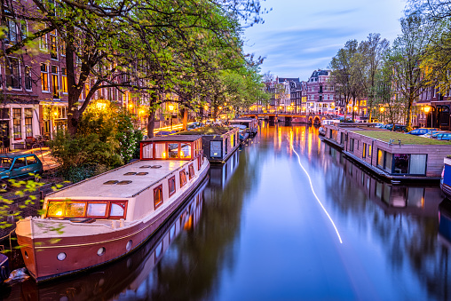Amsterdam city canal with group of houseboats at twilight. The Netherlands