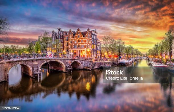 Panoramic View Of The Historic City Center Of Amsterdam Traditional Houses And Bridges Of Amsterdam Town A Romantic Evening And A Bright Reflection Of Houses In The Water Stock Photo - Download Image Now