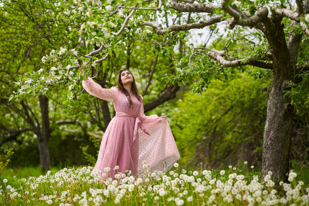 istock Young woman in apple orchard 1399410201