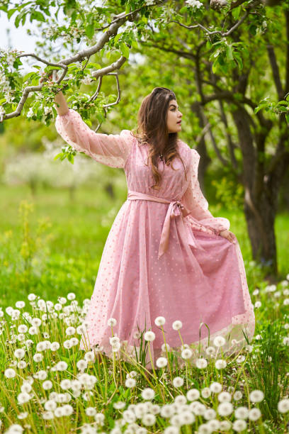 istock Young woman in apple orchard 1399410202
