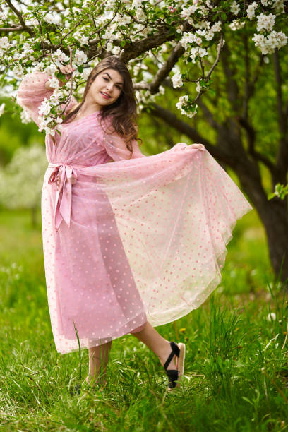 istock Young woman in apple orchard 1399410299