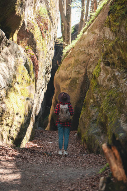 istock woman hiker with backpack walking by trail 1399411965