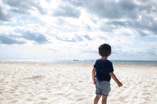istock little boy on the beach 1399416777