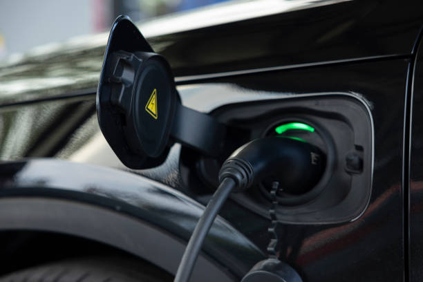 Charging the vehicle at a car park or fuel station. electric vehicle charging station. Pure energy is environmentally friendly of the future world. stock photo
