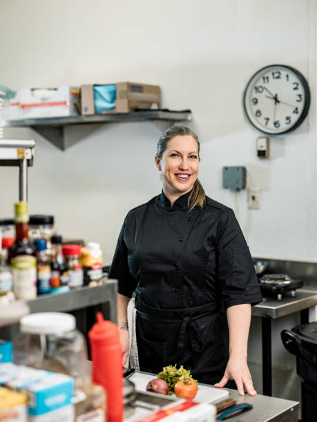 Portrait of female chef at the commercial kitchen