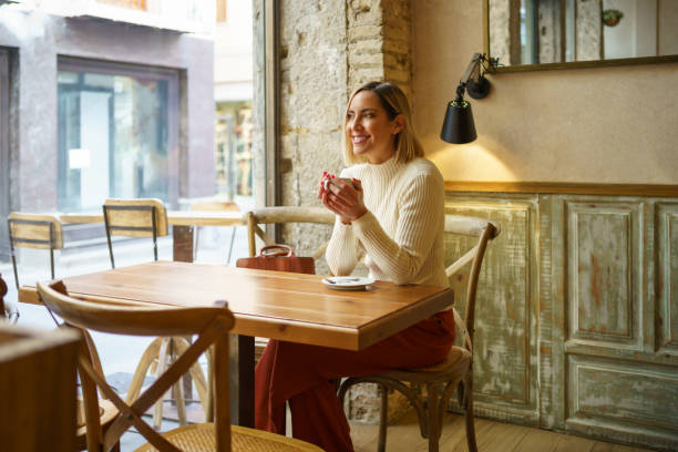 istock Delighted woman with coffee in cafe 1399420412