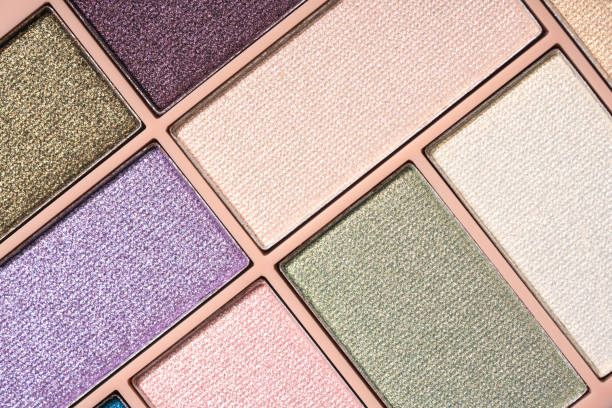 istock Glitter eyeshadows palette for festive makeup as background. Professional make up and beauty concept, flat lay 1399421040