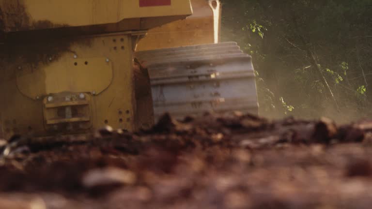 A Bulldozer's Steel Tracks Roll over the Dirt at a Construction Site