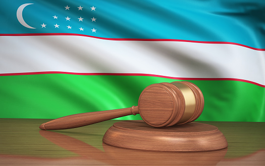 3d Render Judge Gavel and Uzbekistan flag on background (Close-Up)