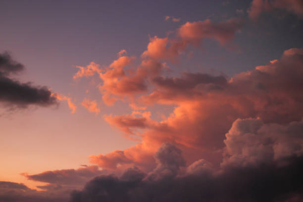 istock large cumulus cloud with shadowed base and top lit by golden twilight light, rising over the horizon. 1399423267