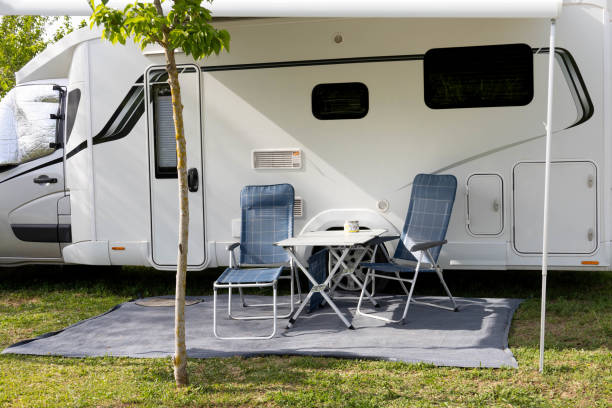 istock Mobile home with two blue chairs prepared to be seated and relaxed in a camping 1399423710