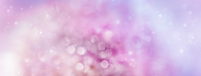 abstract pink-purple background of defocused dandelion and glowing particles and bokeh