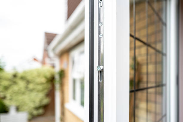 Shallow focus of a metal locking bolt seen on a newly installed double glazed kitchen door. stock photo