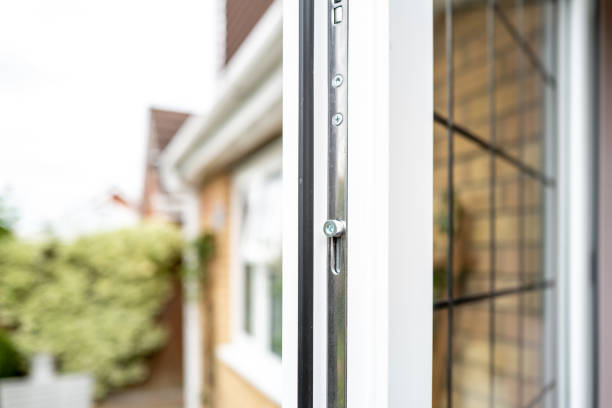 Shallow focus of a metal locking bolt seen on a newly installed double glazed kitchen door. Opening outwards into the patia area of an enclosed garden. key doormat stock pictures, royalty-free photos & images