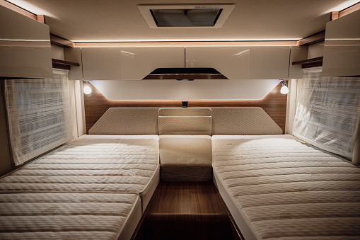 Image of the bed inside a new luxury camper van motorhome.