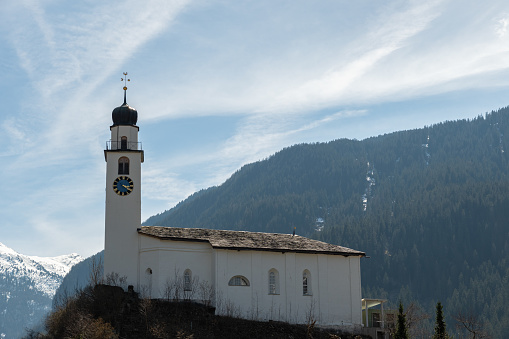 Andeer, Grison, Switzerland, April 12, 2022 Catholic church on top of a little hill on a sunny day