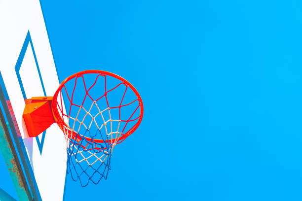Basketball hoop against blue sky Basketball hoop against blue sky back board basketball stock pictures, royalty-free photos & images