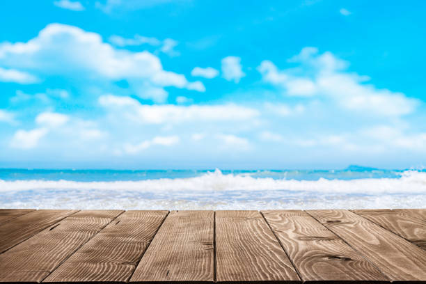istock Empty wooden table with tropical blue beach at background 1399427581