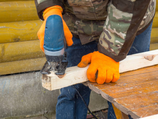 istock Working with power tools. man sawing a board with a jigsaw 1399428946