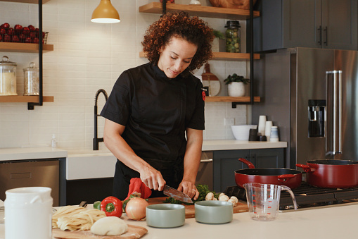 A professional woman chef at work in a modern kitchen.