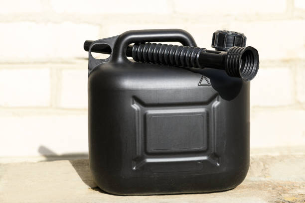 istock Black plastic canister for gasoline with funnel on a brick wall background 1399429405