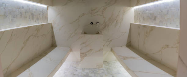 Classic turkish hammam. White turkish bath with marble surfaces. Marble oriental bathroom. Steam bath interior.
