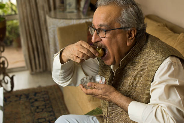 istock Man eating gol gappe or pani poori at home 1399430413