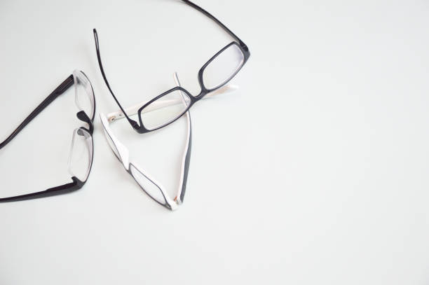 istock Many eyeglasses for vision correction lying isolated on white background. Optics, eye examination, ophthalmology. 1399431480