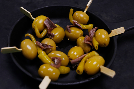 spanish appetizers, skewer with pickled chili, olives and anchovy, known as antipasti