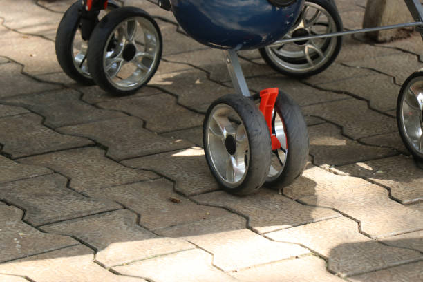 istock Stroller wheels with safety lock laying on interlock tiles on daylight 1399434433