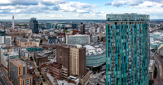 Birmingham, UK - May 24, 2022.  An aerial view of Birmingham city centre with The Radisson Blu Hotel skyscraper, Victoria Square and New Street Train Station