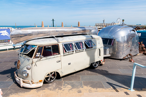 Scheveningen beach, the Netherlands - May 22, 2017: White VW kombi camper wagen and silver trailer at Aircooled classic car show