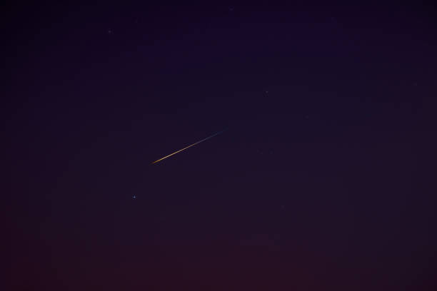 istock Stars, meteor trail on evening sky. 1399434737