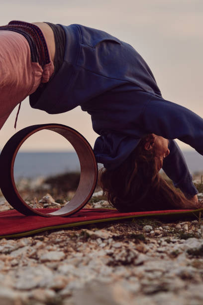 istock Woman practicing yoga outdoors in sunset sunrise time. 1399434897