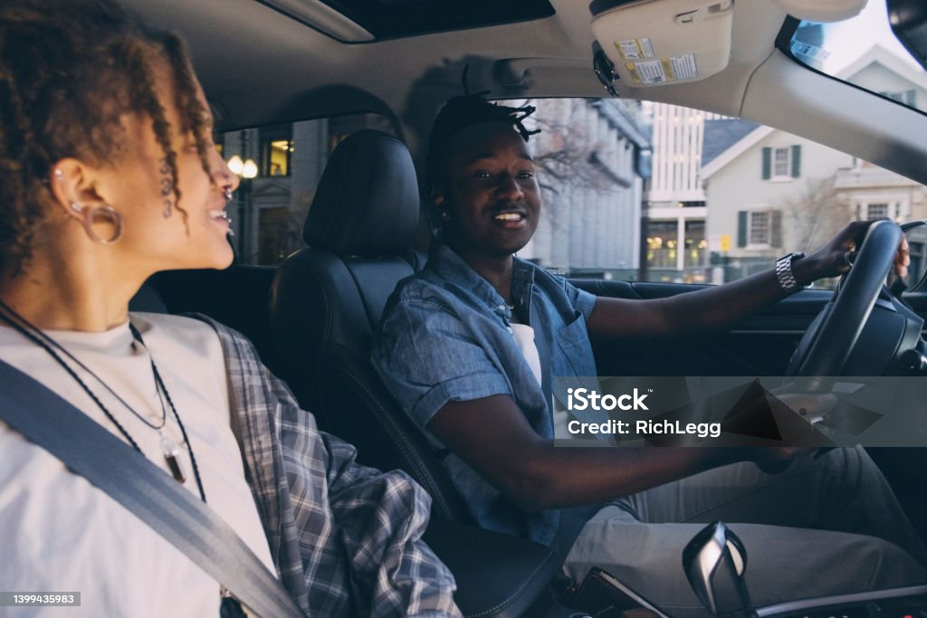 Friends in a Car Young friends driving in an urban city. Car Stock Photo