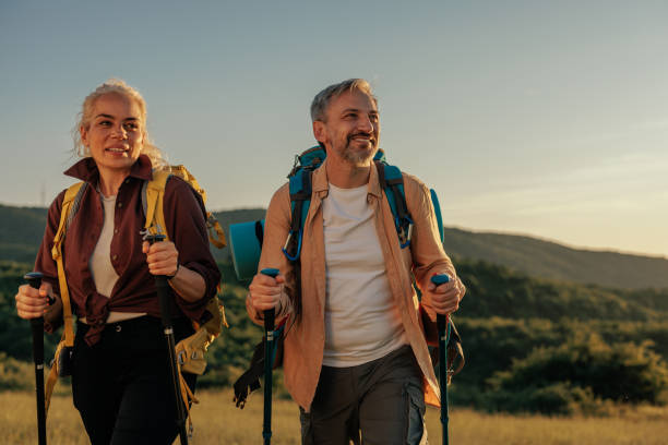istock Middle aged couple trekking in mountains 1399438903