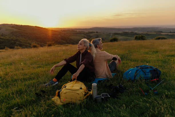istock Traveler couple sitting on meadow while taking a break 1399438907