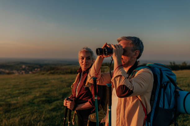 istock Couple with backpack hiking and admiring view in nature 1399438909