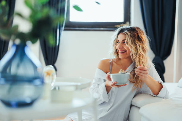 istock Happy young blonde eating at home 1399438956