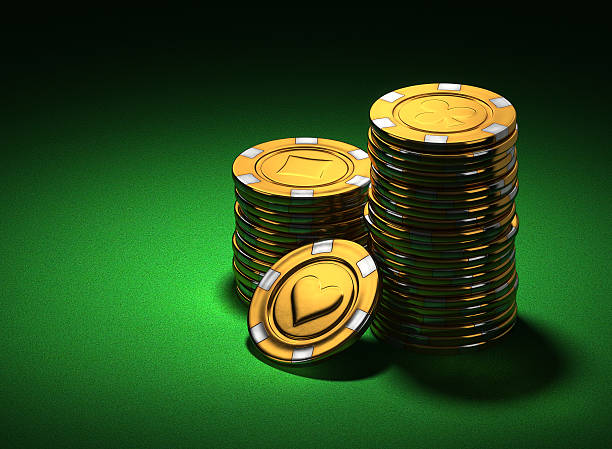 Small group of gold poker chips on green
