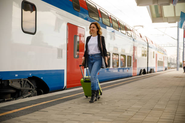 istock Woman pulling her suitcase, walking towards the train she is about to board 1399441761