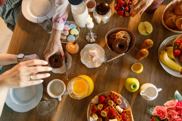 istock Directly above hands reaching for sweet food served on a dining table 1399442616