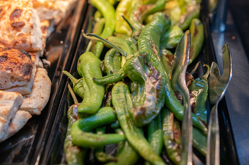 Roasted green peppers and toasted bread at the buffet.