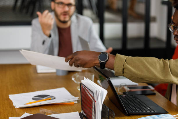 istock Businessman holding documents, reaching his hand as if he is giving it to someone 1399442911