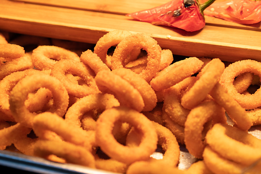 Stack of fried onion or squid rings at restaurant buffet
