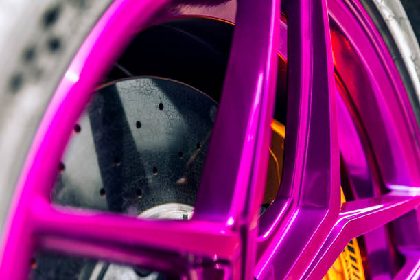 Drilled Brake rotor behind a aftermarket purple wheel
