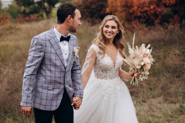 istock Wedding couple with bouquet with roses and spikelets .Boho style in brides hands 1399443453