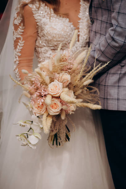 istock Happy bride and groom with boho bouquet in autumn 1399443464