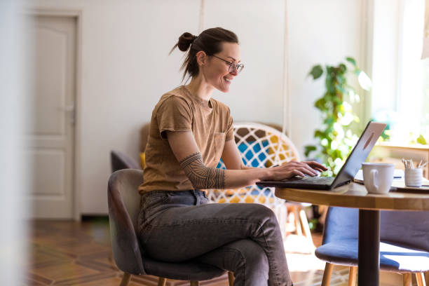 istock Young woman using a laptop at home 1399445962