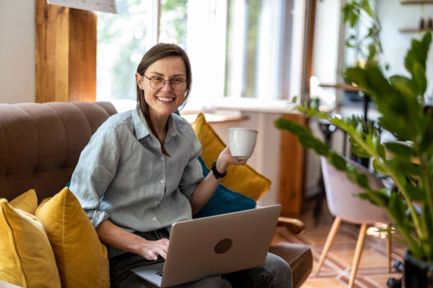 istock Young woman using a laptop at home 1399446931